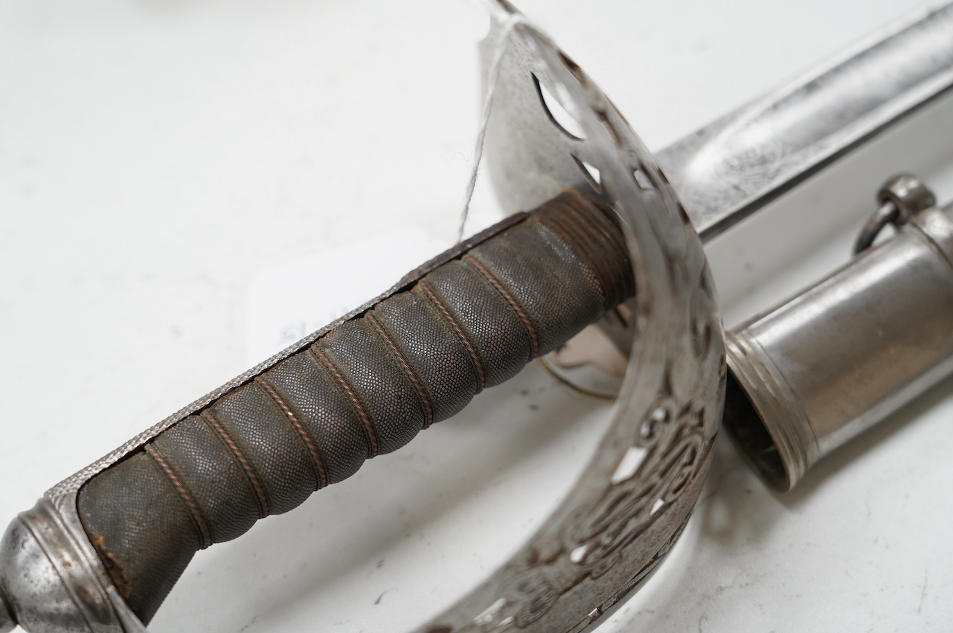 An 1895 pattern late Victorian infantry officer’s sword in its steel scabbard, made by E. Thurkle, 5 Denmark St. Soho, blade 83cm. Condition - good, however scabbard heavily cleaned